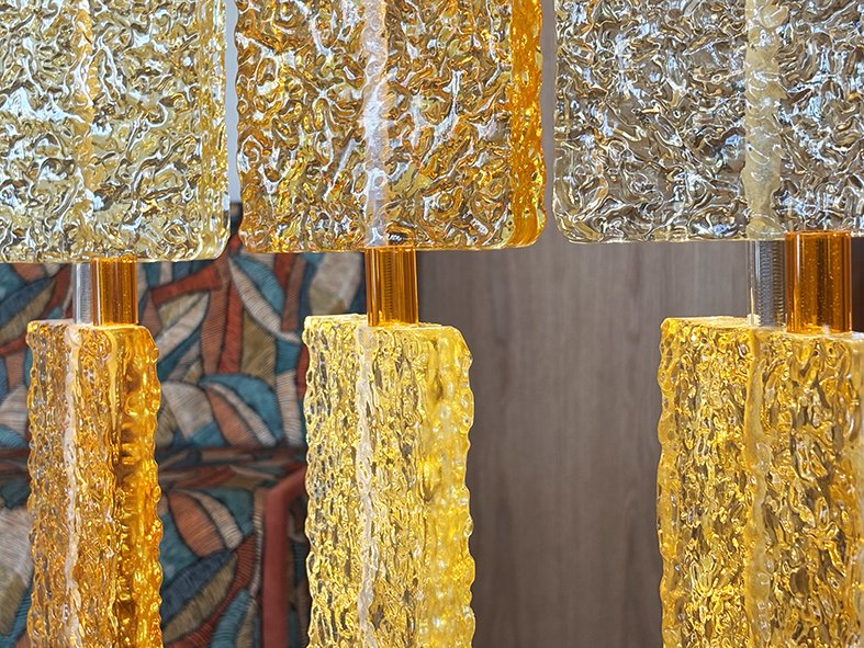 Amber and clear cast glass tiles against a patterned banquette at The BoTree hotel, London