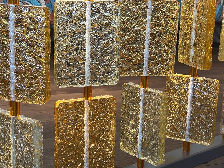 Daylight through heavily textured amber cast glass tiles at The BoTree hotel, London